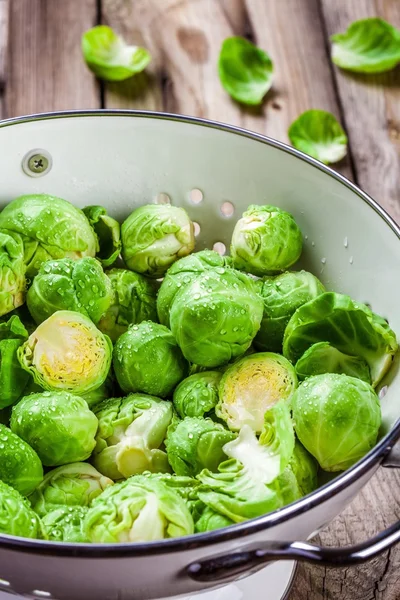 Fresh organic Brussels sprouts in a colander