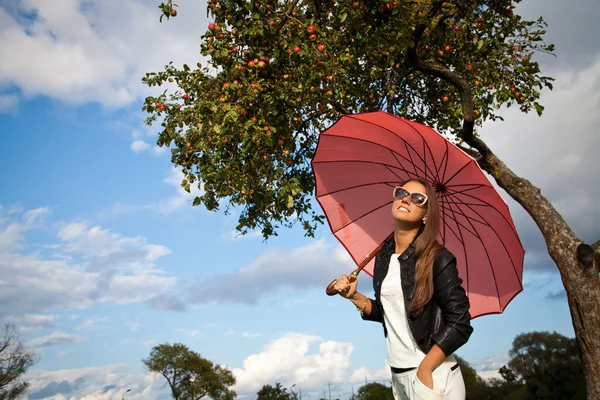 Smiling Woman with Umbrella over Autumn Rain