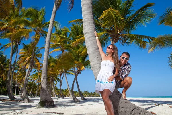 Vacation couple relaxing on beach together in love