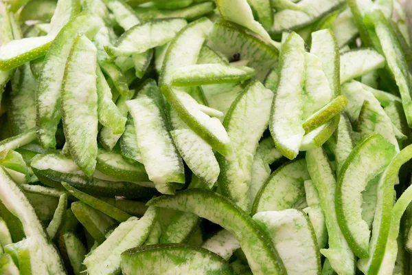 Dried green mango slices as background