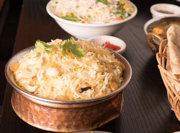 Yummy delicious biryani in a round brass bowl