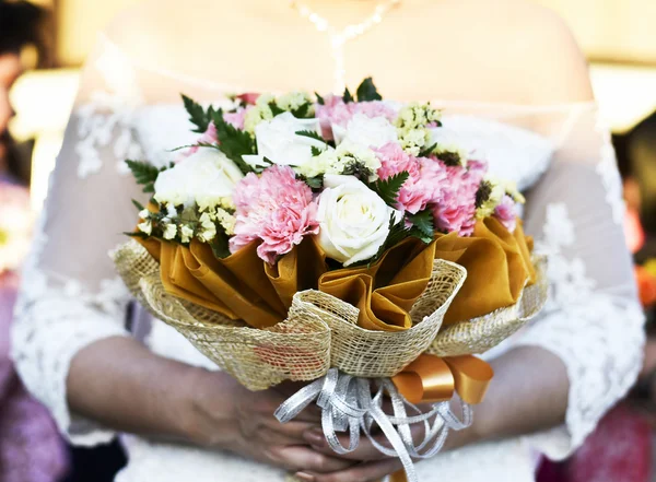 Bride\'s hand holding flowers bouquet