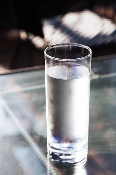 Cold fresh drinking water in glass on table