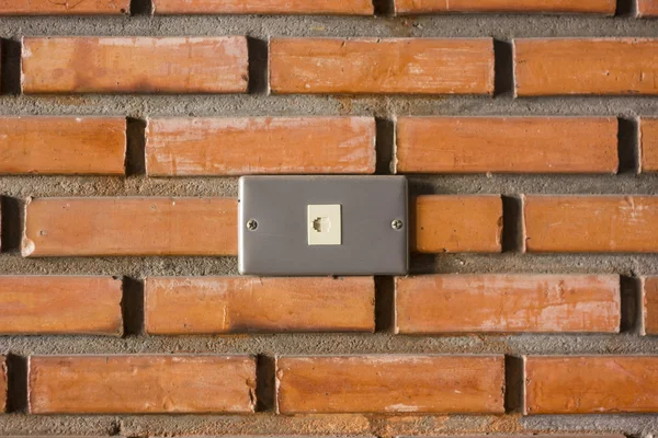 Network plug on brick wall