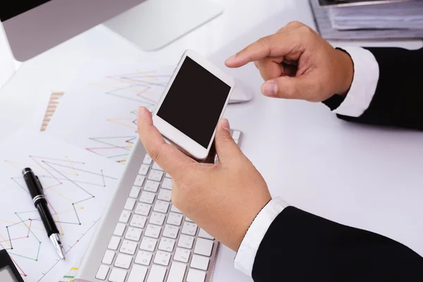 Businessman working with modern devices, computer and mobile pho