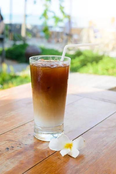 Glass Of Cold Coffee On Wooden table