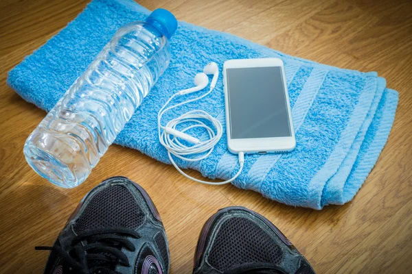 Sport equipment. Sneakers, water , earphones, smart phone