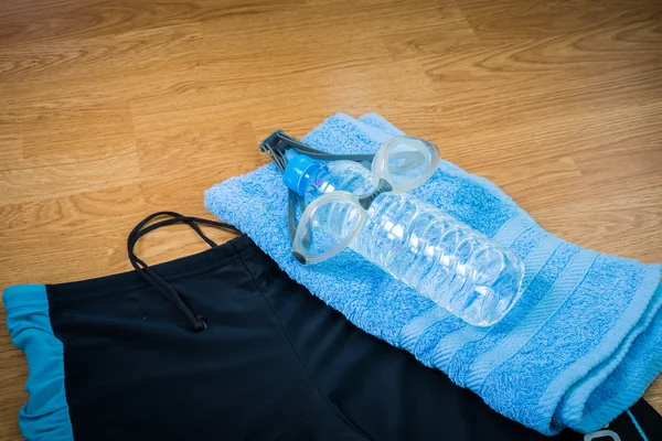 Glasses and Swimming trunks , water Bottles , towel