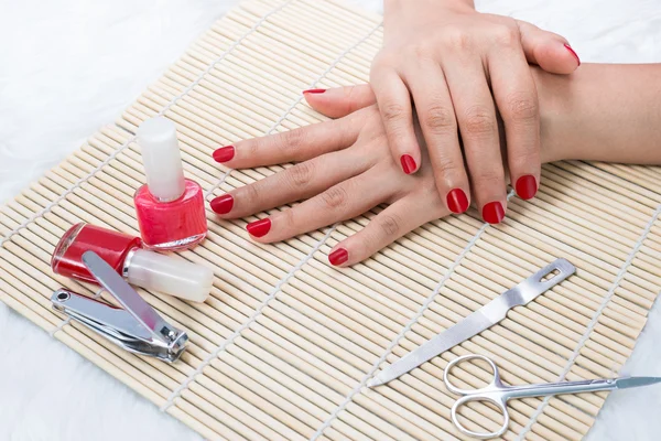 Beautiful manicured woman's nails with red nail polish