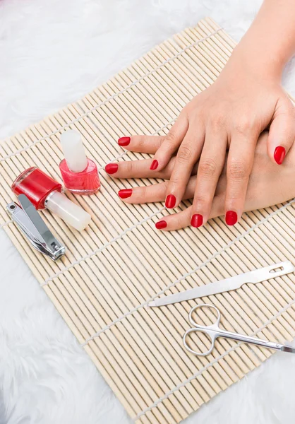 Beautiful manicured woman\'s nails with red nail polish