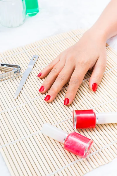 Beautiful manicured woman\'s nails with red nail polish