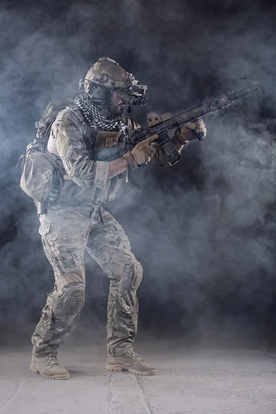 US Army Soldier in Action with goggles in the Smoke