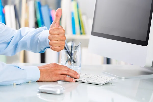 Businessman\'s Hands showing thumbs up at Office