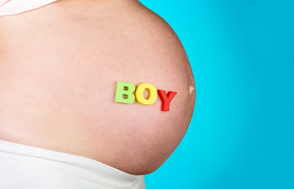 Caption boy on pregnant belly woman