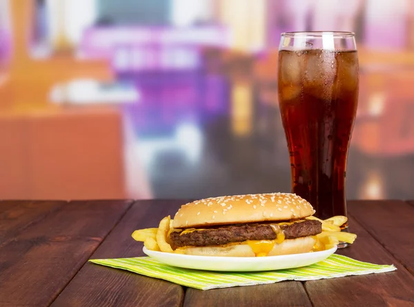 Hamburger with french fries, glass  cola on  background  hall cafe.