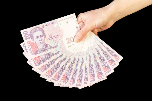 Ukrainian money fanned out in  hand