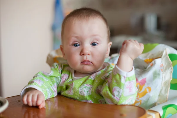 Kid eats at the table. Happy family.