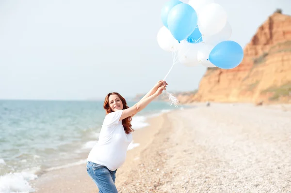 Pregnant woman with balloons
