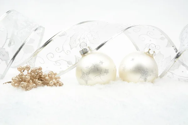 Silver christmas baubles,snowflake with rowan and silver ribbon on snow