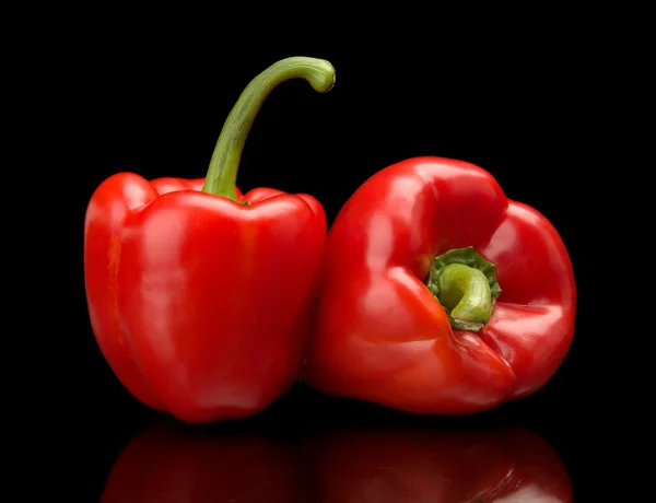 Closeup view of red bell peppers isolated on black