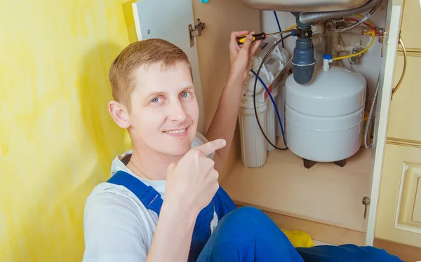 Plumber installs a water filter. water filter.