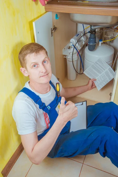 Plumber installs a water filter. water filter.