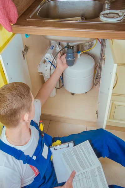 Plumber installs a water filter. water filter.