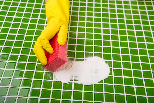 Washing the tiles in the bathroom