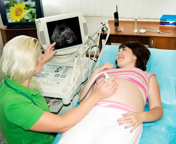 Pregnant woman on reception at the doctor...