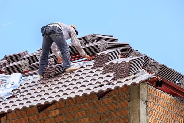 Worker installing roof tile