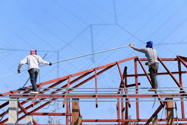 Labor working in construction site for roof prepare