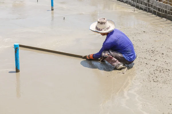 Plasterer concrete worker at floor