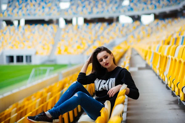 Girl having fun outdoor. Pretty girl sitting at school stadium. Rest from study. Outdoors, Lifestyle