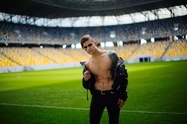 Handsome young man in leather jacket, stadium rocker