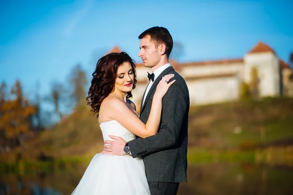 Wedding day. Marriage. Wedding walk outdoors. Newlyweds with bouquet of flowers. Bride and groom portrait. Love, feelings, tenderness. Marriage bond