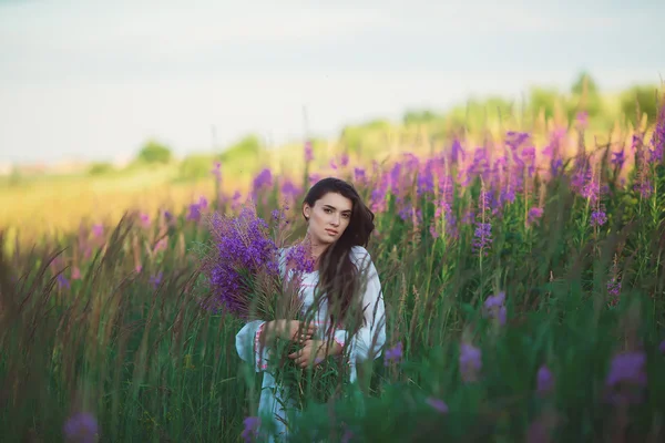 Girl holding flowers in hand, smiling gently