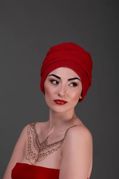 Beautiful young woman, red lips and dress with scarf on head