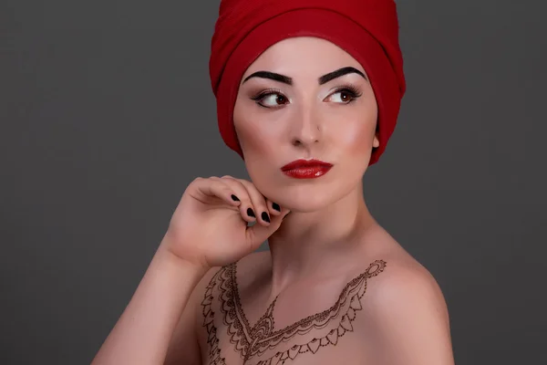 Beautiful woman with arabic make-up, red lips and curls. Beauty