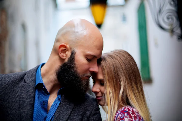 Portrait of man and woman up close, beard and bald