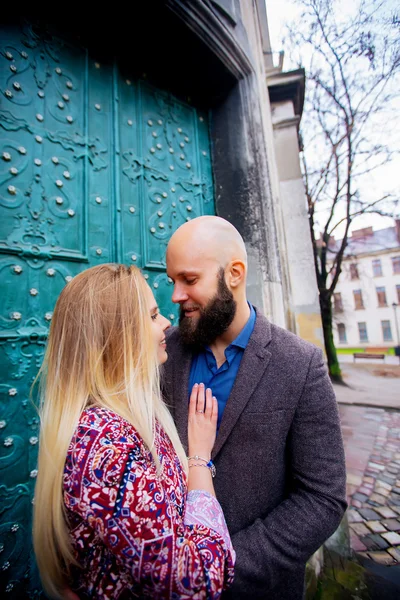 Young fashion elegant stylish couple posing on streets of european city in summer evening weather. Sensual blonde vogue girl with handsome hipster man having fun outdoor.
