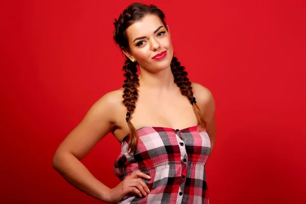 Woman wearing red sweater against red wall background