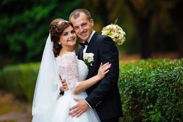 Wedding couple. Beautiful bride and groom. Just married. Close up. Happy bride and groom on their wedding hugging. Groom and Bride in a park. wedding dress. Bridal wedding, autumn