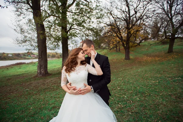 Wedding couple hugging and kissing in a private moment of joy