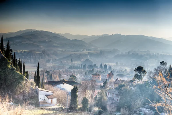 Tile roofs of Italian country village in the mist
