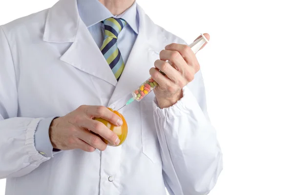 Man in medical white coat makes an injection to beefsteak tomato