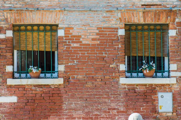 Windows on the brick wall of venetian house