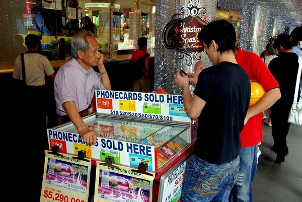 Singapore: Men Shopping for Phone Cards