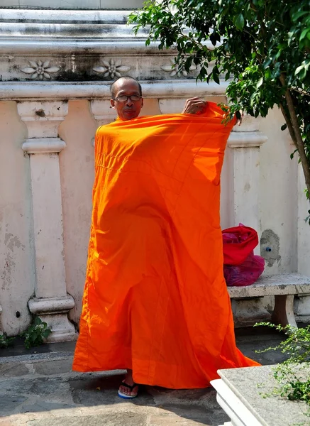 Bangkok, Thailand: Monk Wrapping Robe on his Body
