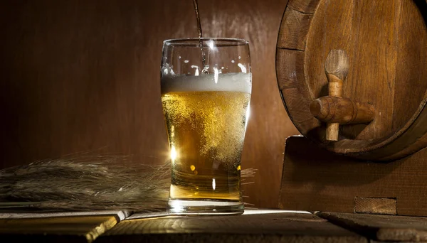 Beer barrel with beer mug on wooden background