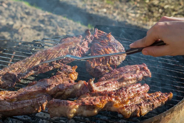 Closeup of meat cooking in the barbecue outdoor